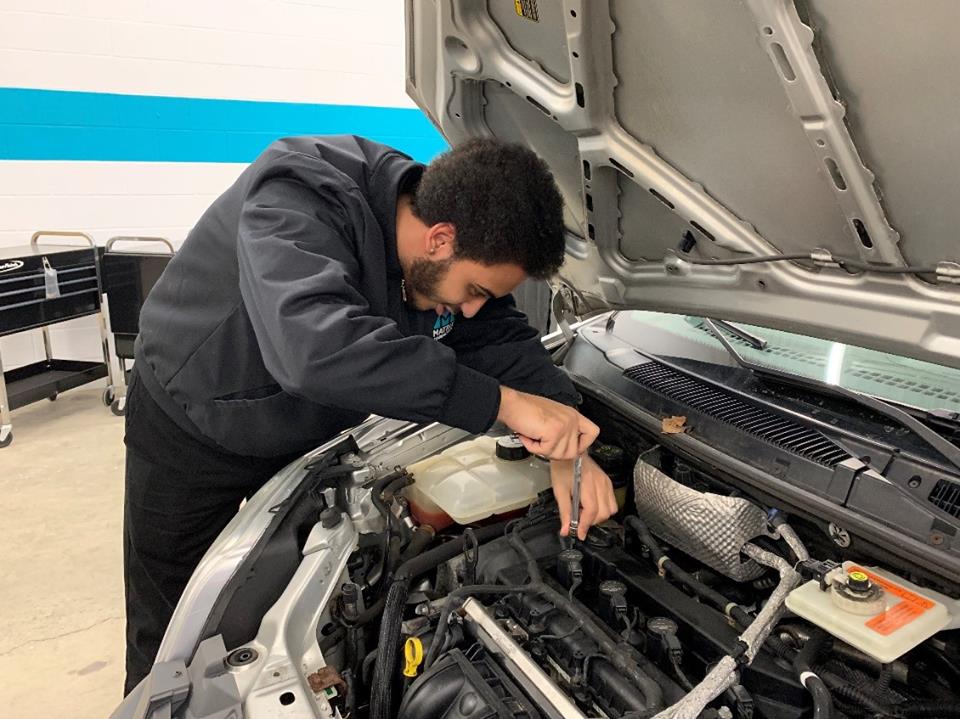 Auto mechanic student learns by doing.